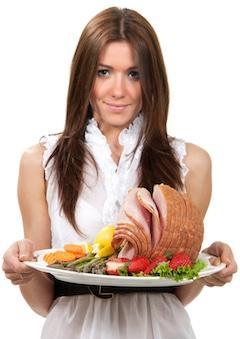 woman holding ham dish