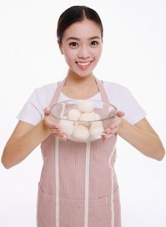 woman holding egg bowl with white background
