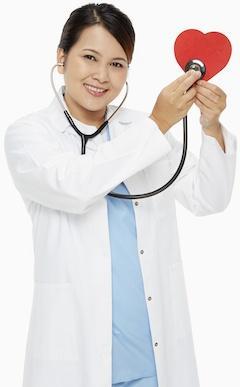Medical personnel placing a stethoscope against a red heart