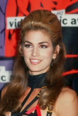 American supermodel Cindy Crawford wears a black Versace dress to the MTV Music Video Awards, 1992. (Photo by Bob Scott/Fotos International/Getty Images)