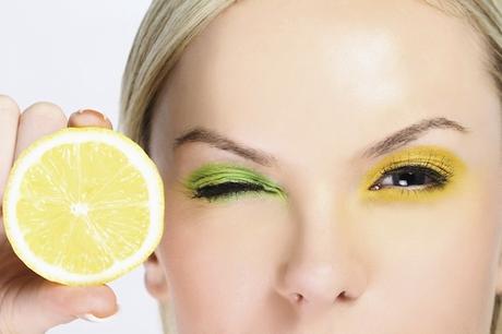 woman with lemon next to eye