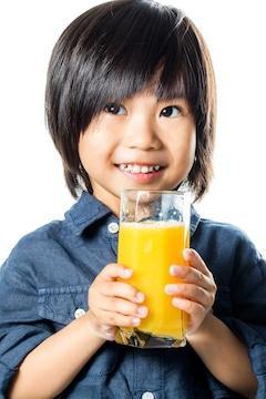 boy drinks vitamin c enriched orange juice