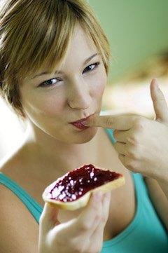 Woman eating bread with jam