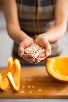 housewife holding pumpkin seeds