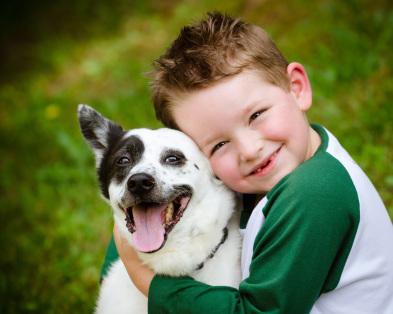 Child hugging dog