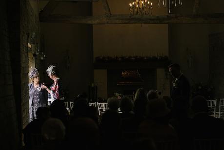 two women standing in light at wedding 