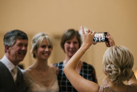 bridesmaid taking a photo on her phone 