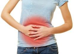woman holding stomach with digestion issues