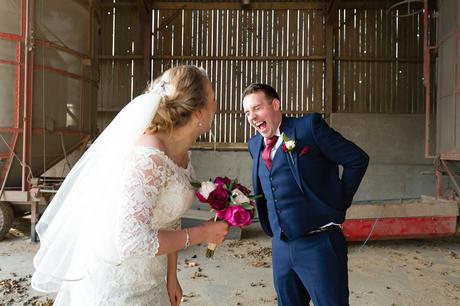 Bride & groom laughing in the barn at The Normans wedding venue in York