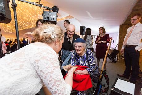 Bride gives cake to grandmother at York wedding