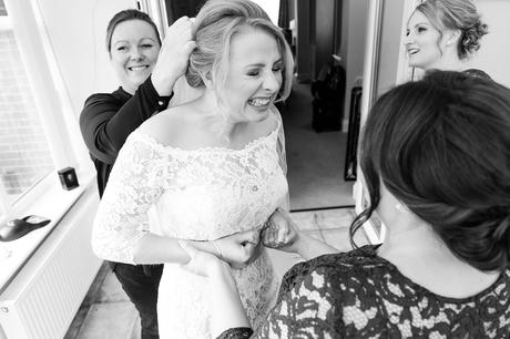 Bride makes silly face when putting in veil at York wedding