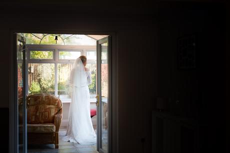 Full length photograph of bride framed in doorway