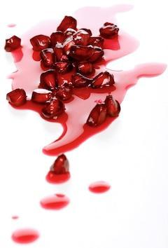 Close-up of pomegranate seeds on white background