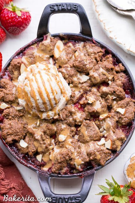 This Strawberry Crisp with Almond Butter Crumble is an irresistible pairing of fresh strawberries and a lightly-sweetened, rich and crispy almond butter cookie crumble. You won't be able to resist this gluten-free, paleo, and vegan dessert.