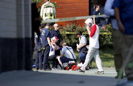 One of the people injured in the shooting is pictured being treated by paramedics