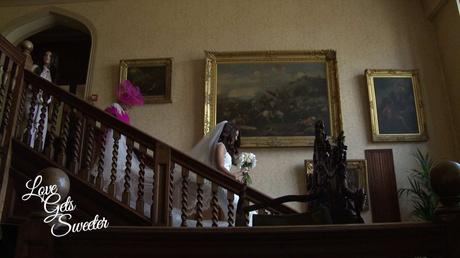 Bride and her Mum making their way down the old staircase at Armthawaite Hall for the wedding videographer