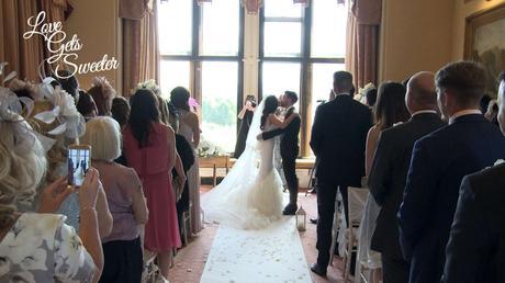 the bride and groom enjoy a kiss after being announced as husband and wife at armathwaite hall in the lakes
