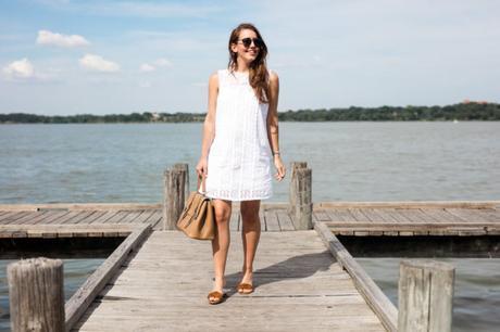 Amy Havins wears a white eyelet shift dress.