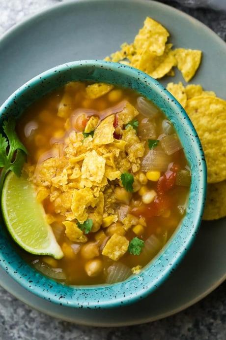 Slow cooker chickpea tortilla soup which can be assembled ahead of time and stored in the fridge or freezer! A great way to stay out of the kitchen this summer.