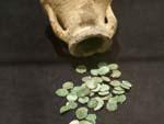 Some turquoise coins in a clay pot