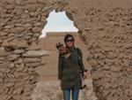 Sonya at the entrance of a mud brick wall