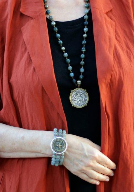 Detail: style blogger Susan B. of une femme d'un certain age wears stone bead jewelry with vintage French medallions.