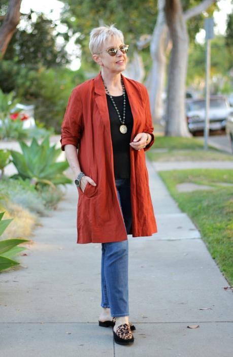 style blogger Susan B. wears a copper lightweight jacket from Eileen Fisher, jeans, and leopard mules. 
