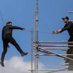 Tom Cruise jumps between two buildings in a scene from the new Mission Impossible film