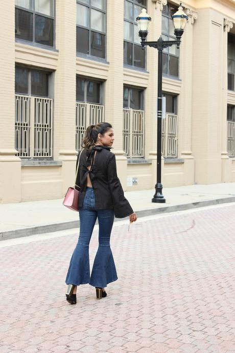 how to wear the 70's trend, bell bottom legs, jeans , wide leg jeans, flared ruffle hem jeans, bow back blouse, black blouse, street style, fashion week style, atlantic city, myriad musings 