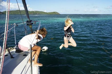 kids jumping off sailboat