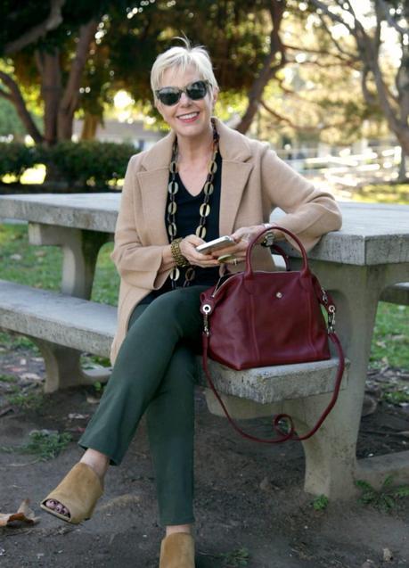Checking my messages. Wearing J.Crew sweater blazer, Longchamp bag. Details at une femme d'un certain age.