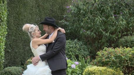 bride wearing Ian Stuart wedding dress and cowboy groom in a black stetson during their farm wedding in Yorkshire