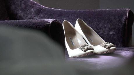 Manolo blahnik wedding shoes in champagne color on a purple velvet chair at a wedding in drighlington