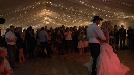 bride and groom having a first dance to Prince with the bride wearing Ian Stuart and Groom a Stetson