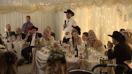 groom making a speech during his marquee wedding on a working farm
