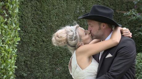 bride and groom have a big kiss during their farm wedding before their wedding photographs in drighlington