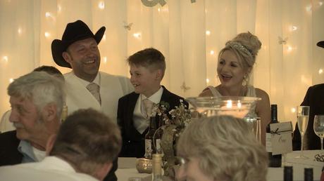 bride and groom laughing during the best man speech at their drighlington wedding