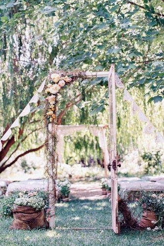 old door wedding decoration vintage white with flowers leads to the wedding aisle feather and stone photography