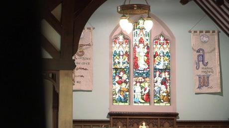 stained glass window in Rhyl church before a christening