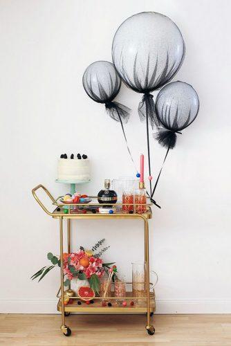 wedding shower decor ideas a golden wheelbarrow on wheels with booze and desserts is decorated with balloons aileen allen via instagram