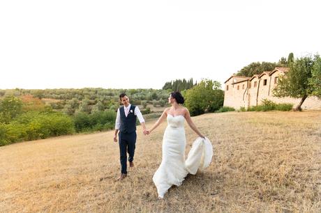 Villa Catignano Siena Wedding Photography bride and groom walk through fields in Italy
