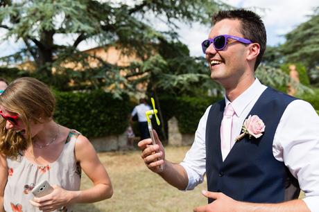 Villa Catignano Siena Wedding Photography groom in sunglasses with portable fan
