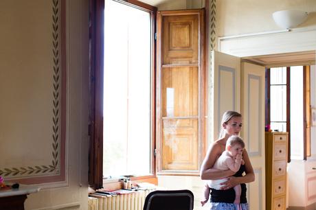 Bridesmaid holds baby in Italian Villa