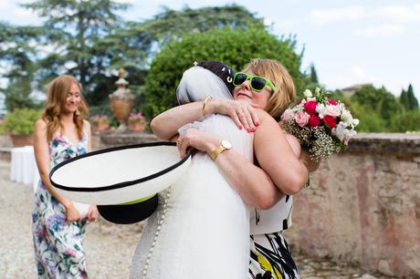 Bride hugs guest at wedding in Italian Villa