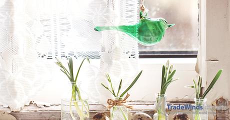 Fragment of Easter interior on ols windowsill with little glass vials, blossom snowdrops,  glass bird and quail eggs. See series