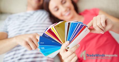 Happy young couple lying on the floor of new house and looking at colorful palette