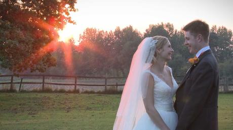 A bride and groom chat naturally as the sun sets during a winter wedding at Willington Hall