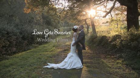 Bride and Groom having a cuddle and kiss with the winter sun low behind them peeking through the trees at Whitley Hall for the wedding video