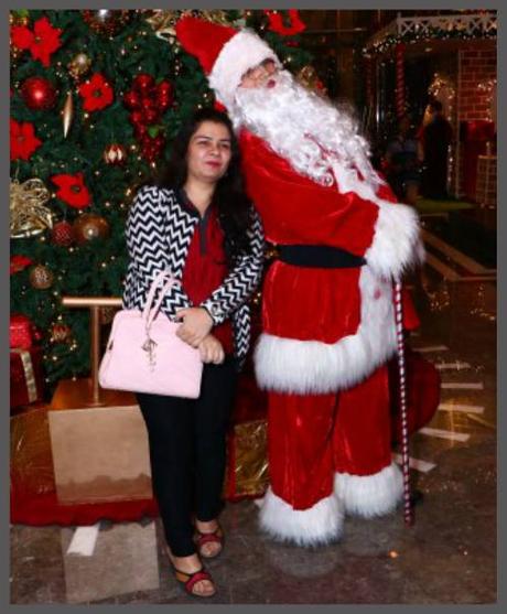 Anjali stand with Santa