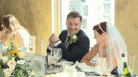 the bride and groom smile at each other during the wedding speeches at On The 7th